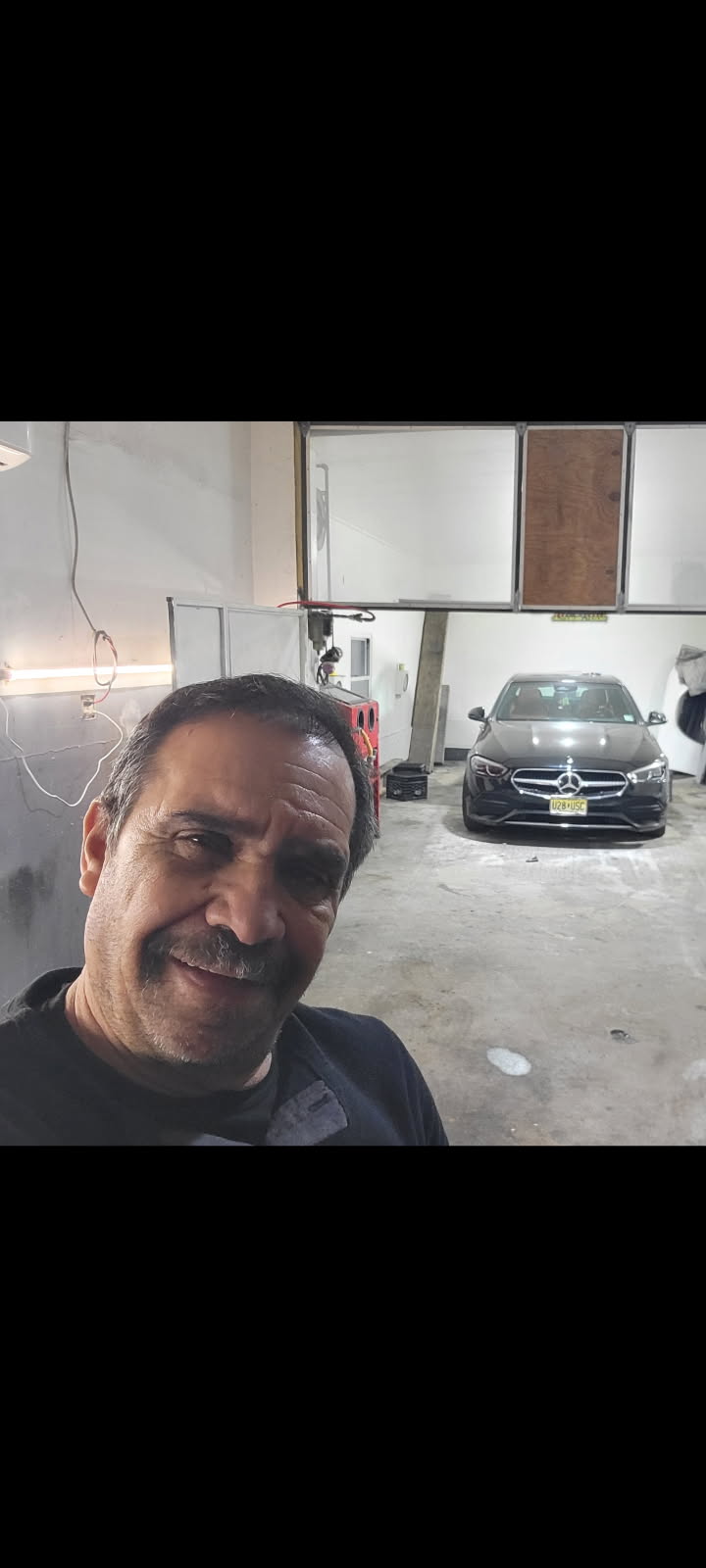 Adolfo Cano inside the Liberty Avenue auto body repair shop