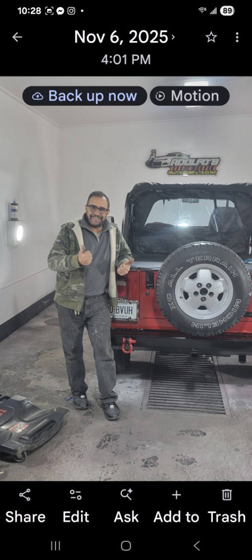 Customer beside an off-road vehicle serviced at Adolfo's Auto Body
