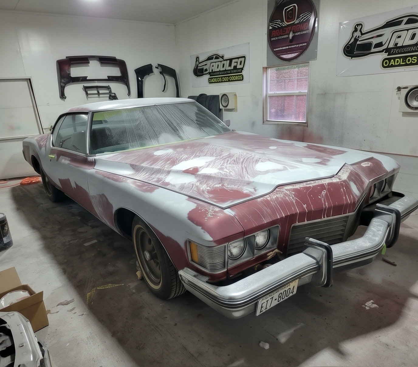 Classic red vehicle masked and sanded for auto body refinishing